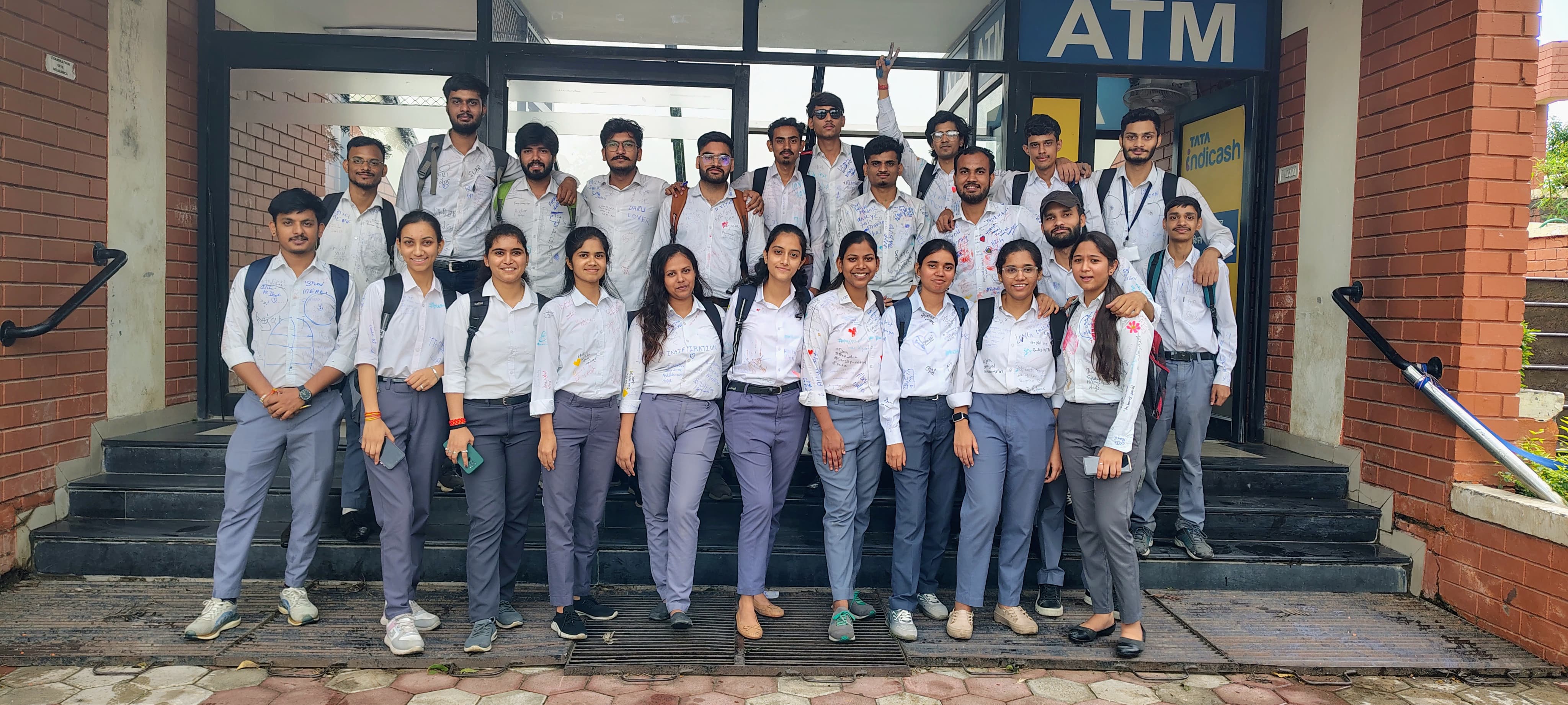 Students posing in front of college building